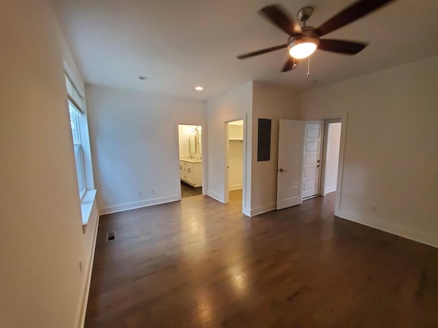 interior space featuring recessed lighting, dark wood-type flooring, visible vents, baseboards, and a walk in closet