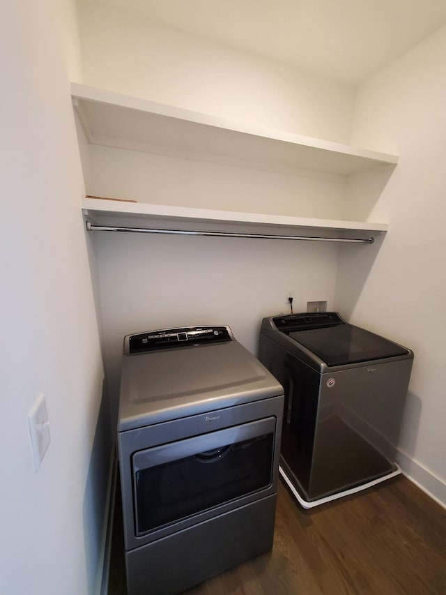 laundry room featuring laundry area, washing machine and dryer, dark wood-style floors, and baseboards