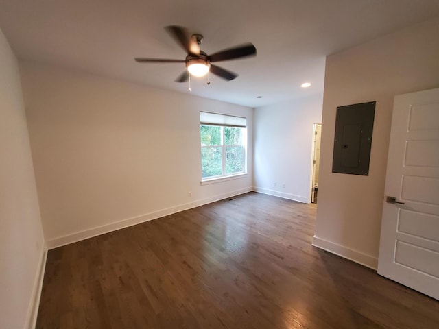 empty room with dark wood-style floors, recessed lighting, ceiling fan, electric panel, and baseboards