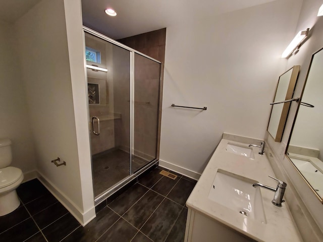 bathroom with a sink, toilet, and tile patterned floors