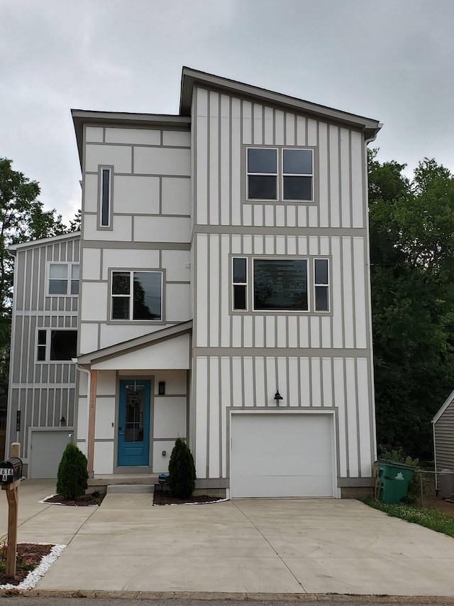 view of front of property with an attached garage, board and batten siding, and concrete driveway