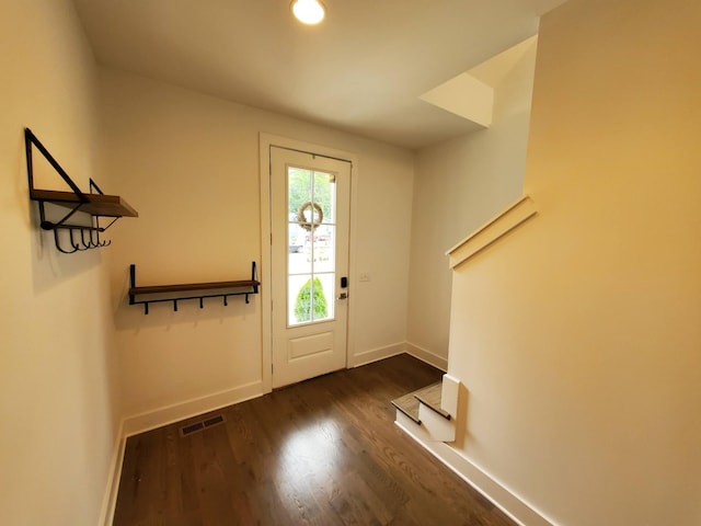 foyer entrance with stairway, visible vents, baseboards, and dark wood-type flooring