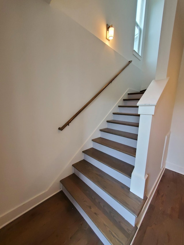 stairway featuring wood finished floors