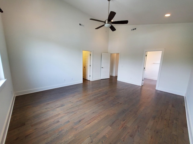 interior space featuring ceiling fan, dark wood finished floors, visible vents, and baseboards