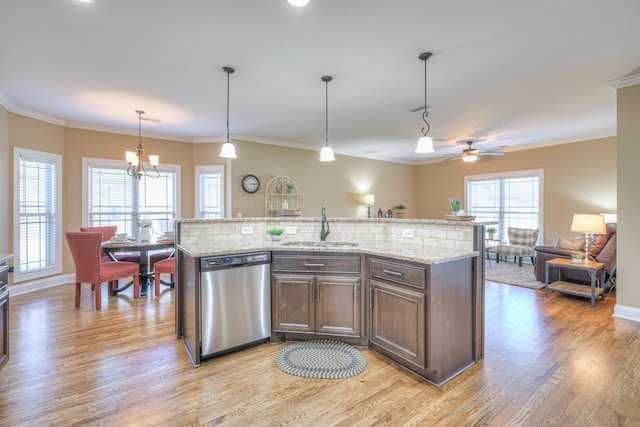 kitchen featuring light wood finished floors, crown molding, dark brown cabinets, stainless steel dishwasher, and a sink