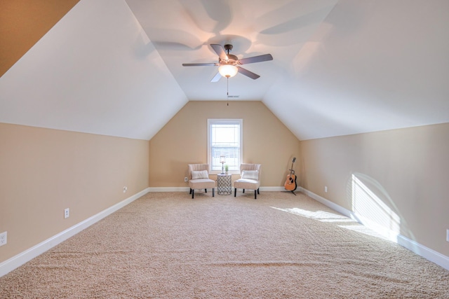 unfurnished room with lofted ceiling, carpet, and baseboards