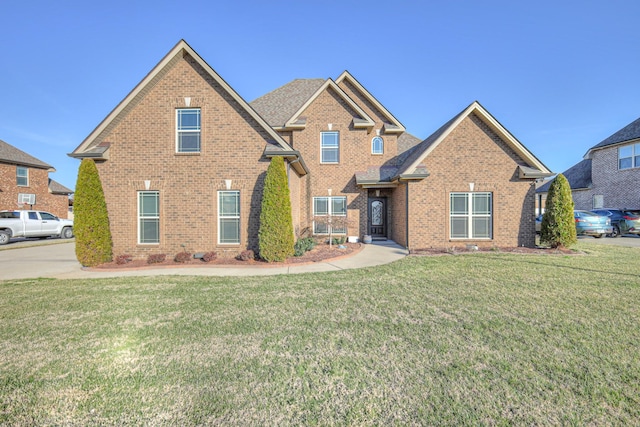 traditional home with brick siding and a front lawn