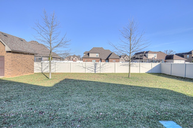 view of yard with a residential view and a fenced backyard