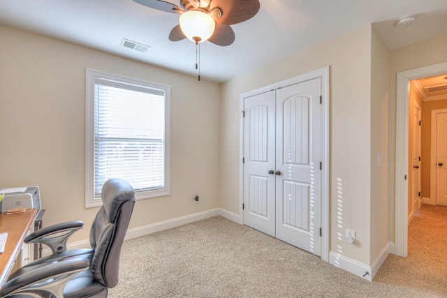 carpeted home office featuring ceiling fan, visible vents, and baseboards