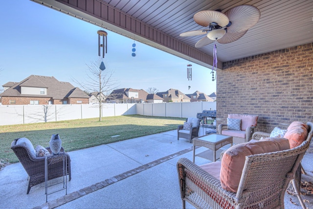 view of patio featuring a fenced backyard, a residential view, an outdoor living space, and a ceiling fan