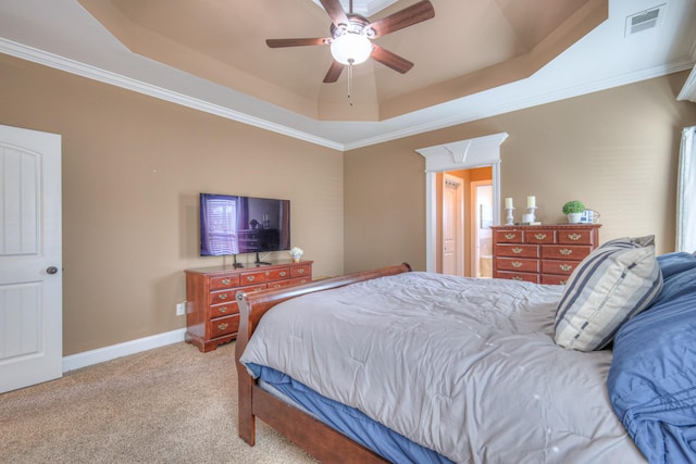 bedroom featuring light carpet, visible vents, baseboards, a raised ceiling, and crown molding