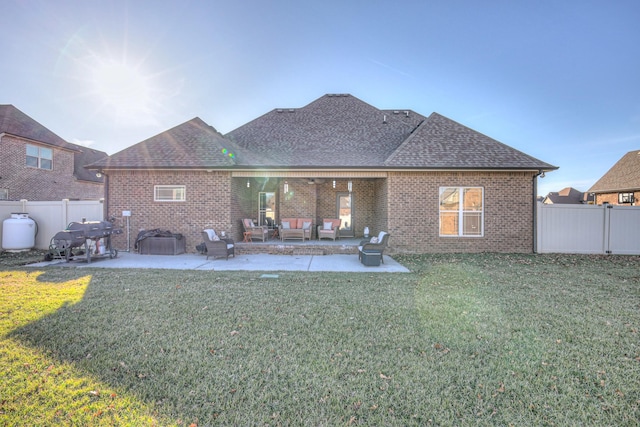 rear view of house featuring a patio area, an outdoor hangout area, and brick siding