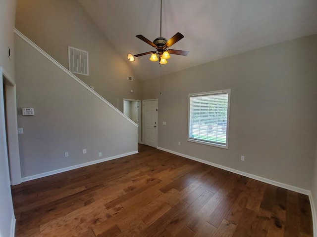 unfurnished living room featuring baseboards, visible vents, a ceiling fan, wood finished floors, and high vaulted ceiling