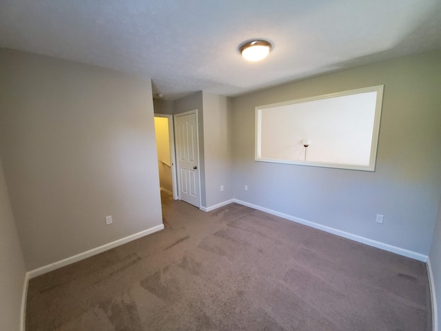 empty room with carpet flooring and baseboards