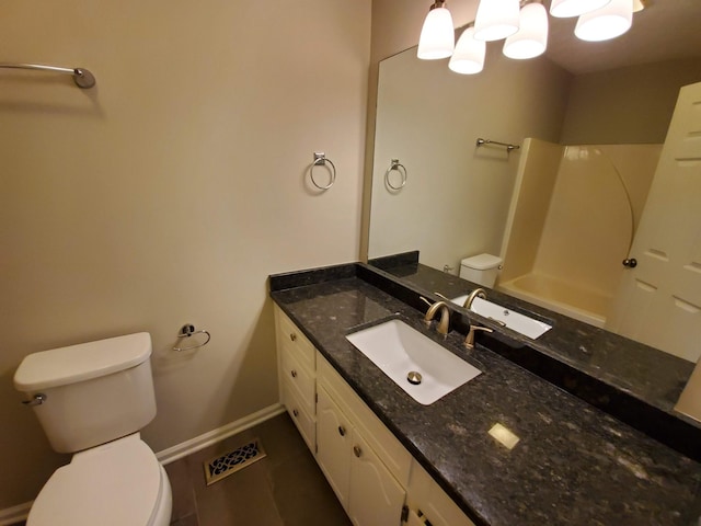 full bathroom with baseboards, vanity, and toilet