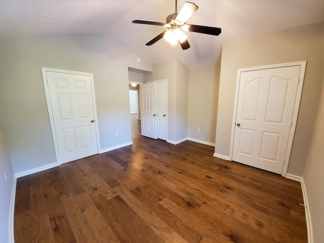 unfurnished bedroom with vaulted ceiling, ceiling fan, dark wood finished floors, and baseboards