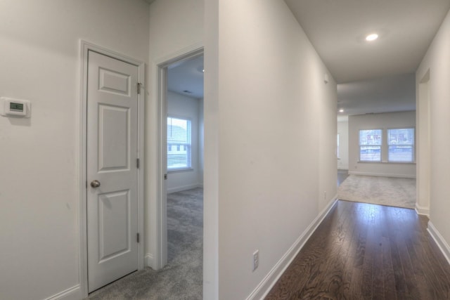 hall featuring recessed lighting, baseboards, and wood finished floors