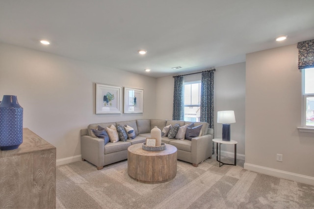 living room with recessed lighting, visible vents, baseboards, and light colored carpet