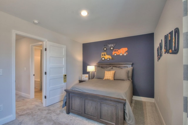 bedroom featuring light colored carpet and baseboards