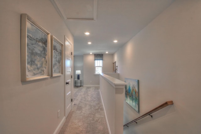 hall with recessed lighting, baseboards, light carpet, and an upstairs landing