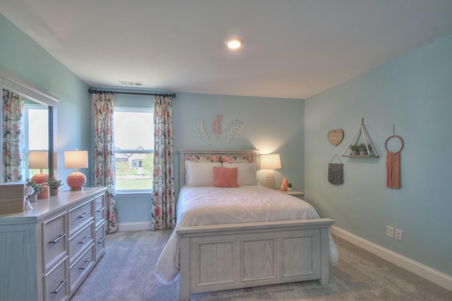 bedroom featuring light colored carpet, visible vents, and baseboards