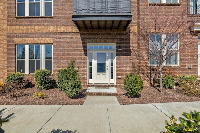 doorway to property with brick siding