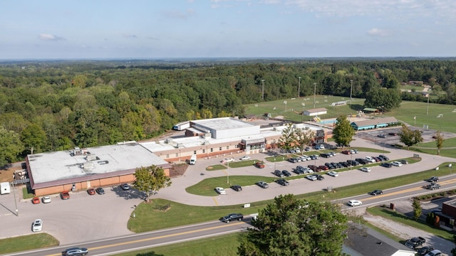 birds eye view of property with a wooded view