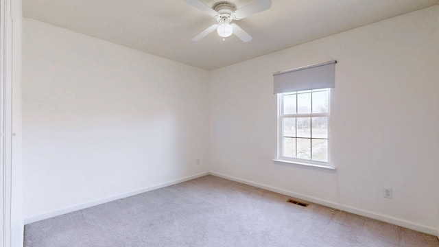 unfurnished room featuring visible vents, baseboards, ceiling fan, and carpet flooring