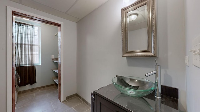 bathroom featuring tile patterned flooring, vanity, and baseboards