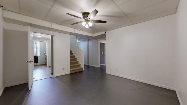 below grade area featuring stairway, ceiling fan, and baseboards