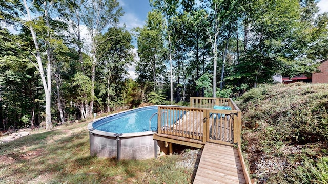 view of swimming pool with a deck