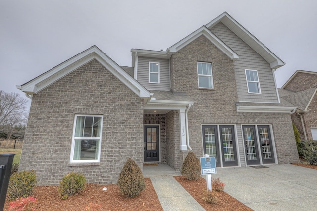 view of front of home with a patio area and brick siding