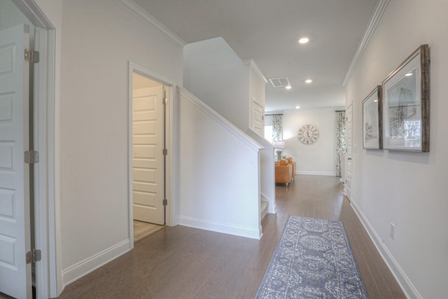 hall featuring crown molding, visible vents, and wood finished floors