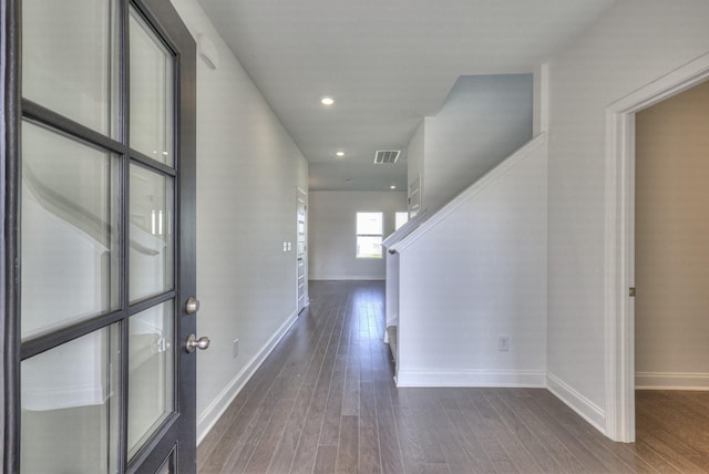 foyer entrance with dark wood-style floors, recessed lighting, visible vents, and baseboards