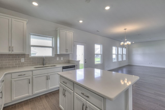 kitchen with dark wood finished floors, tasteful backsplash, recessed lighting, a sink, and dishwasher