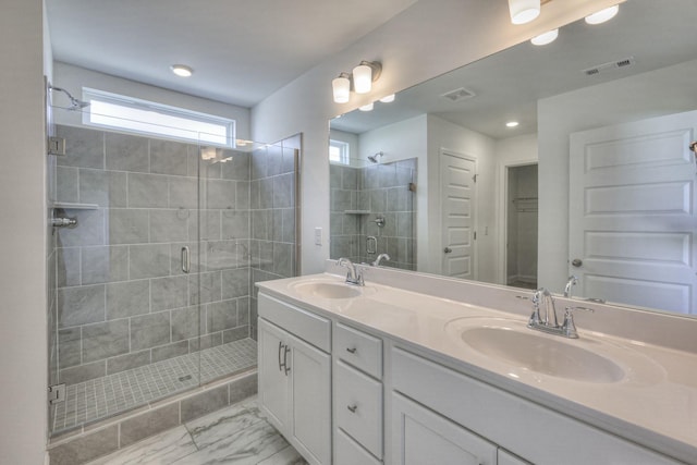 bathroom featuring a sink, visible vents, and a shower stall