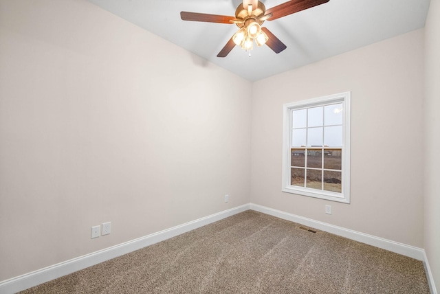 empty room featuring visible vents, carpet flooring, a ceiling fan, and baseboards