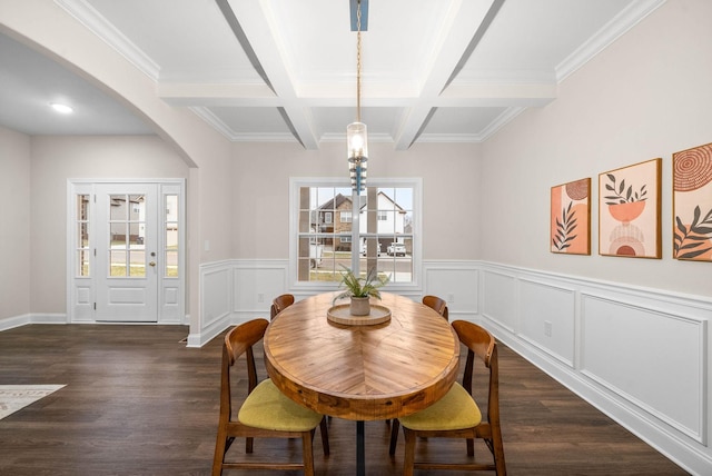 dining space with arched walkways, coffered ceiling, beam ceiling, and dark wood-style flooring