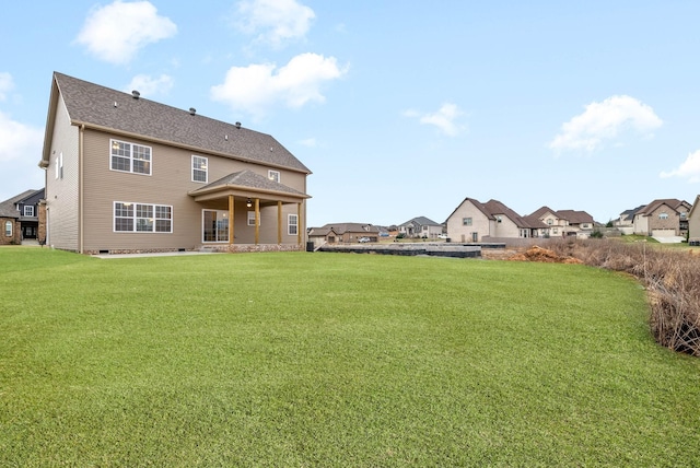 rear view of property with crawl space and a yard