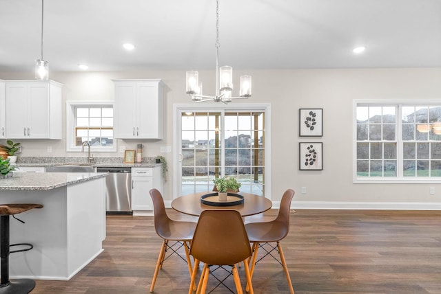 dining space with an inviting chandelier, dark wood-type flooring, recessed lighting, and a wealth of natural light