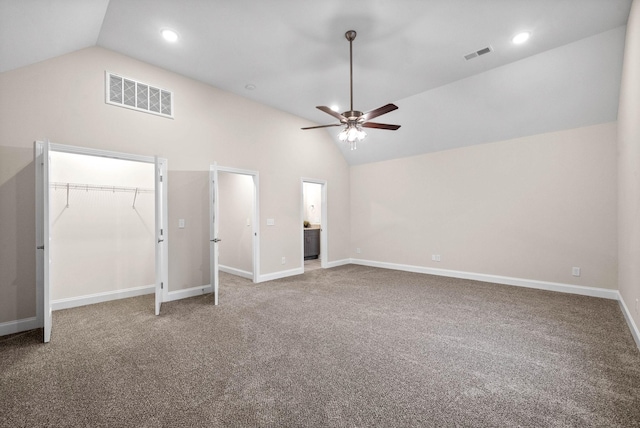 interior space with visible vents, baseboards, and vaulted ceiling