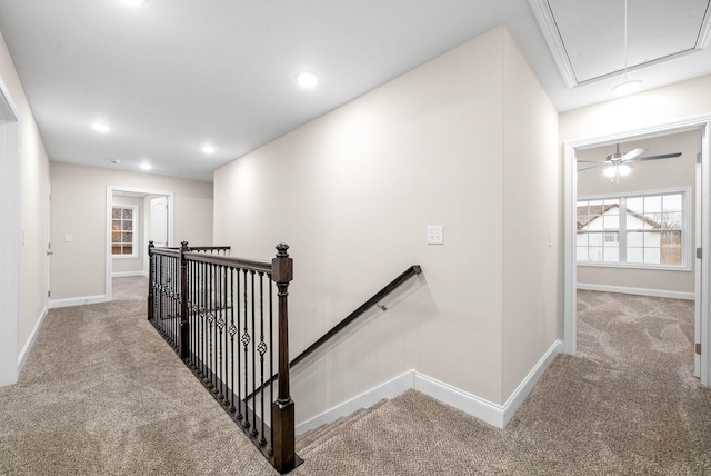 hall featuring recessed lighting, an upstairs landing, carpet, and attic access