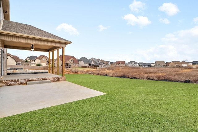 view of yard featuring a residential view and a patio area