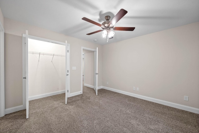 unfurnished bedroom with a closet, carpet floors, baseboards, and ceiling fan