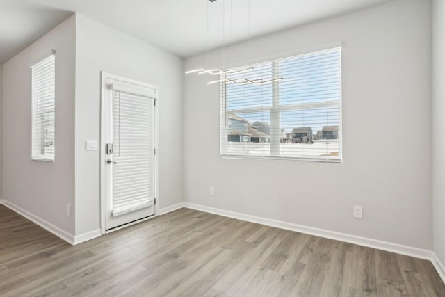 interior space with baseboards and wood finished floors