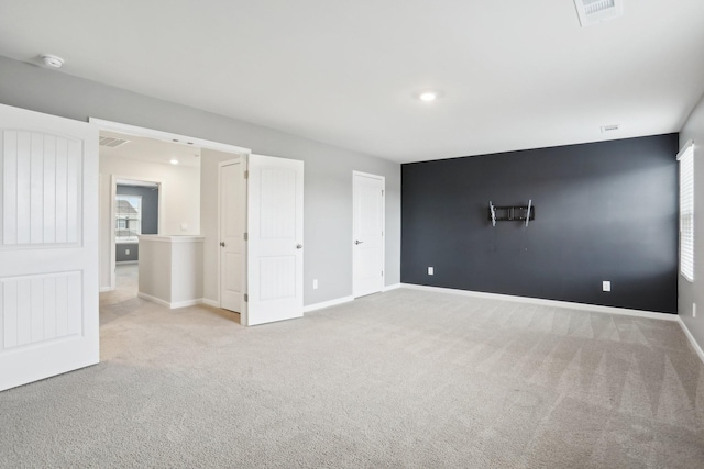 unfurnished bedroom featuring recessed lighting, carpet flooring, visible vents, and baseboards