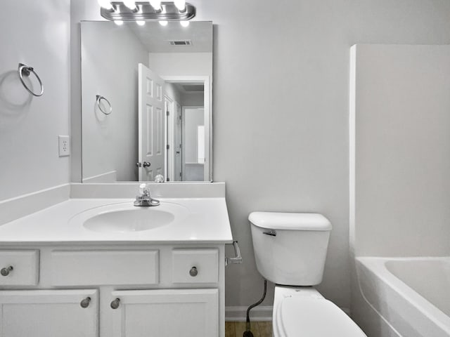 full bath with toilet, vanity, visible vents, and baseboards