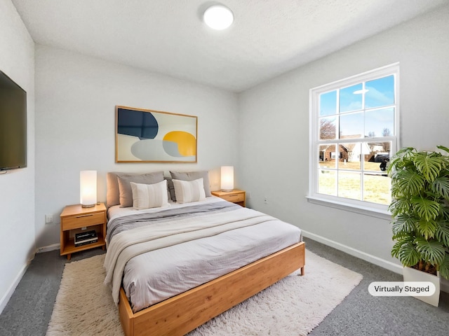 bedroom with carpet floors and baseboards