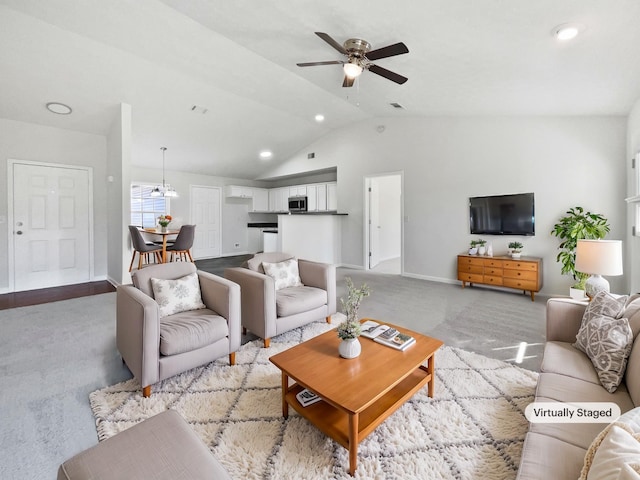 living room featuring lofted ceiling, light colored carpet, visible vents, baseboards, and ceiling fan with notable chandelier