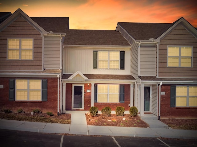 townhome / multi-family property featuring brick siding